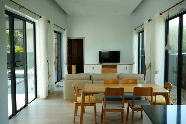 High-Ceiling Living & Dining Hall with 6-Seat Teak Dining Set